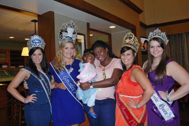 Shown during the visit are, from left, Ana Popich, Miss Plaquemines Parish Seafood Queen; Miss Gonzales Jambalaya, Meredith Conger; the child with her mother; Hope Macaluso is Miss Sicilian Heritage Festival, and Kacie Petito, Miss Amite Oyster Festival.