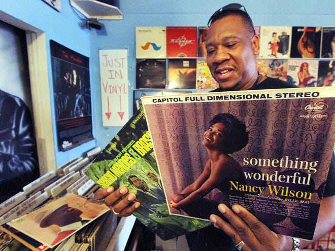 Atlantic Sounds customer Will Thomas searches through some old LPs, looking for some of the music he listened to with his mother when he was young. Thomas, who lives in Lake Mary and works in Daytona Beach, is a regular customer.