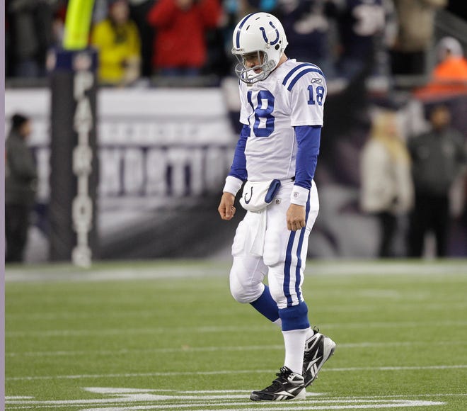 Indianapolis Colts quarterback Peyton Manning (18) walks off the field after throwing an interception in the waning seconds of the fourth quarter against the Patriots.