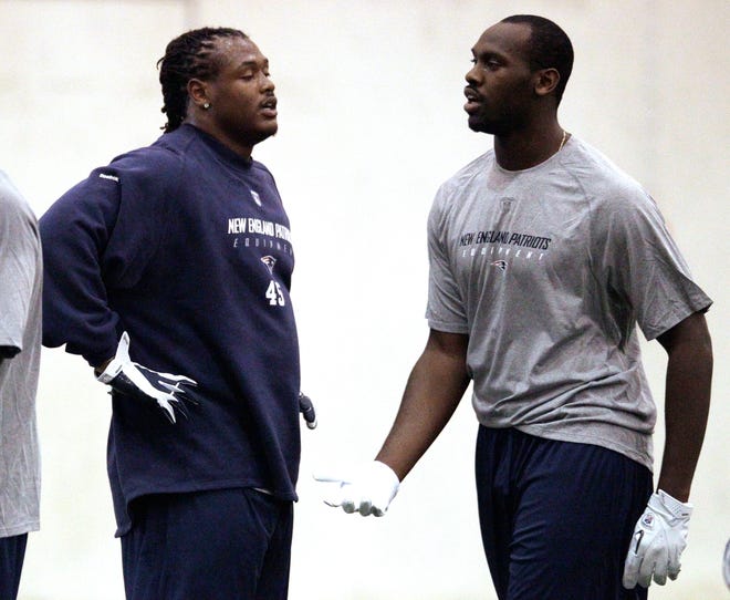 New England Patriots defensive rookie players Dont'a Hightower (45) and Chandler Jones, both selected in the first round of the draft, catch their breath during rookie mini camp practice at the NFL football team's facility in Foxborough, Mass., Friday, May 11, 2012. (AP Photo/Stephan Savoia)