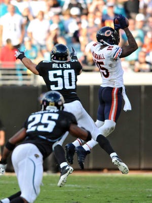 Bob.Mack@jacksonville.com Brandon Marshall grabs a jay Cutler pass for 7 yards in front of Russell Allen in the third quartern Sunday at EverBank Field.