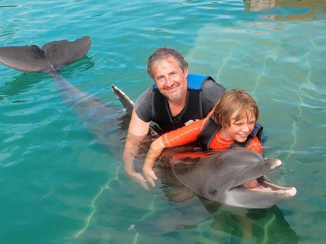 David and son Jonah teach Nemo, a
bottle-nose dolphin, some tricks in the Florida Keys.
