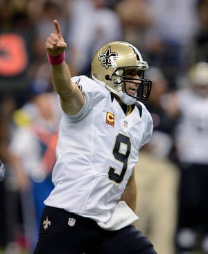 New Orleans Saints quarterback Drew Brees (9) reacts after completing a touchdown pass for his 48th consecutive game, breaking Johnny Unitas' NFL record which stood for over 50 years, during an NFL football game against the San Diego Chargers at the Mercedes-Benz Superdome in New Orleans on Sunday. (AP Photo/Bill Feig)