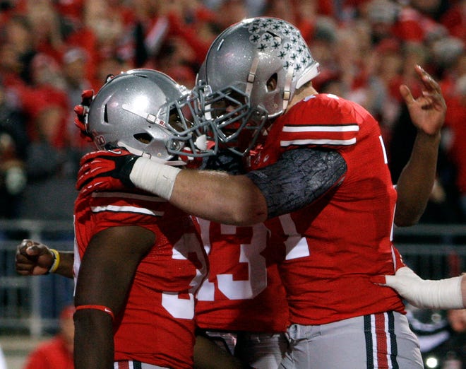 Ohio State running back Carlos Hyde, left, celebrates his touchdown against Nebraska with teammate Reid Fragel during the second quarter of an NCAA college football game, Saturday, Oct. 6, 2012, in Columbus, Ohio.