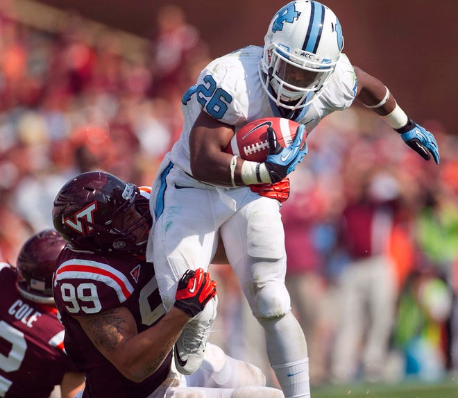 North Carolina's Giovani Bernard, top, breaks a tackle against Virginia Tech's James Gayle on Saturday en route to a career-high 262 rushing yards.