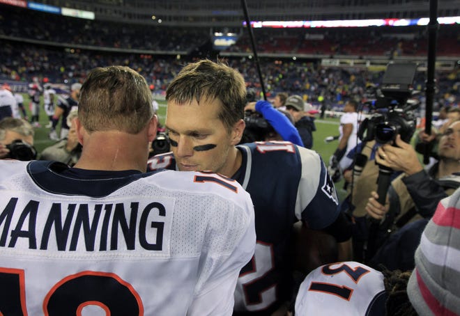 Broncos quarterback Peyton Manning and Patriots quarterback Tom Brady speak in the middle of the field after the Pats' 31-21 victory on Sunday afternoon at Gillette Stadium.