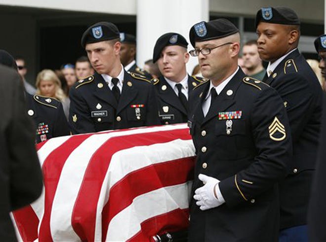 Pallbearers carry the casket of a slain Army soldier in Oklahoma in September.