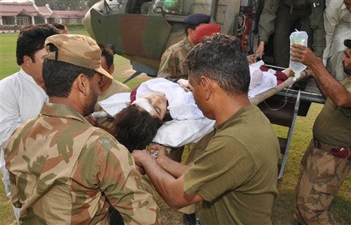 In this photo released by Inter Services Public Relations department, Pakistani soldiers carry wounded Pakistani girl, Malala Yousufzai, from a military helicopter to a military hospital in Peshawar, Pakistan. A Taliban gunman walked up to a bus taking children home from school in Pakistan's volatile Swat Valley Tuesday and shot and wounded the 14-year-old activist known for championing the education of girls and publicizing atrocities committed by the Taliban, officials said. (AP Photo/Inter Services Public Relations Department)