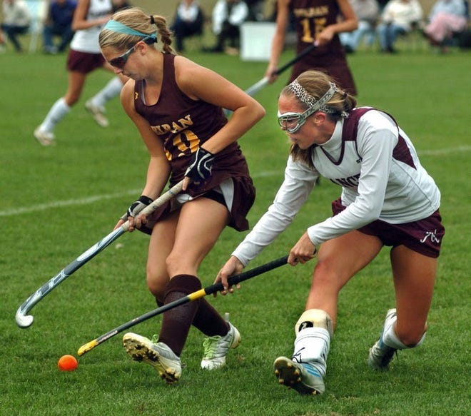 From left- Delran's #19 Caitlyn Cristella and Holy Cross' #8 Casey Kozieja, battle for ball during first half of field hockey game at Holy Cross High School in Delran.