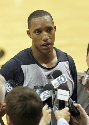 The Sixers' Evan Turner talks to reporters during training camp.