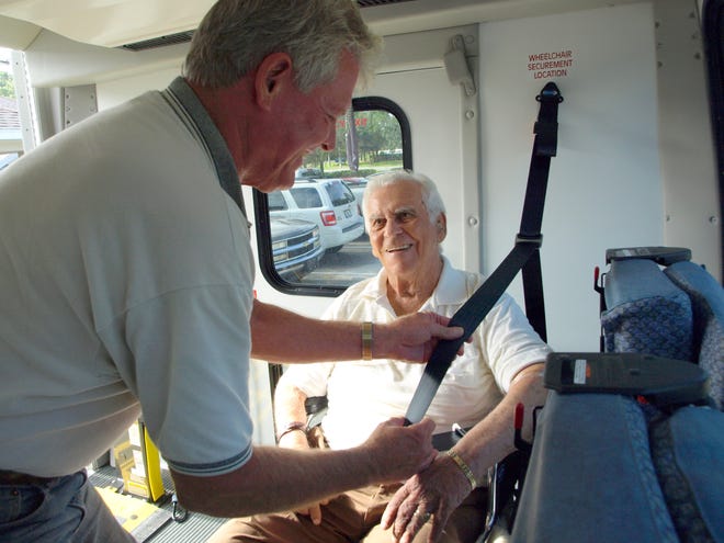 Flagler County bus driver John Jarosz and Palm Coast resident Michael Montaruli share a laugh Tuesday. Montaruli uses the county bus service to bring him for dialysis three times a week.