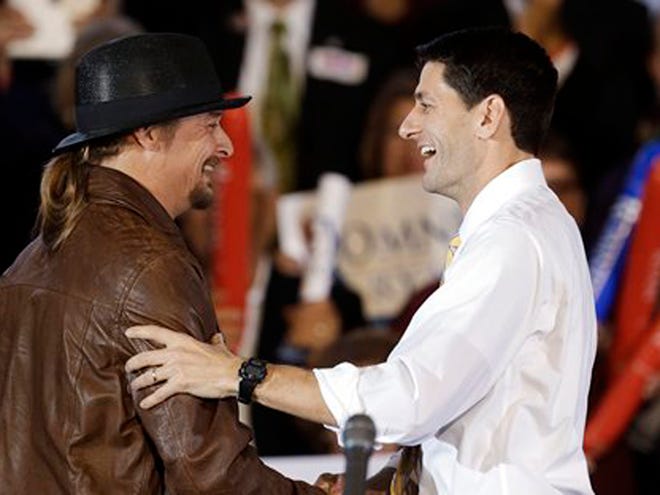 Republican vice presidential candidate, Rep. Paul Ryan, R-Wis., right, is introduced by recording artist Kid Rock at a rally at Oakland University in Rochester, Mich., Monday, Oct. 8, 2012. (AP Photo/Paul Sancya)