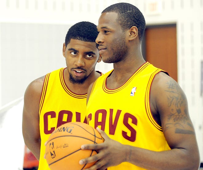 Cleveland Cavaliers guard Kyrie Irving, left, watches guard Dion Waiters as they have their photos taken during their NBA basketball media day at the team's training facility in Independence, Ohio, Monday, Oct. 1, 2012. (AP Photo/Phil Long)