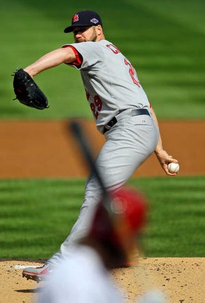 St. Louis Cardinals starting pitcher Chris Carpenter throws to the Washington Nationals in the first inning of Game 3 of the National League division baseball series on Wednesday, Oct. 10, 2012, in Washington. (AP Photo/Pablo Martinez Monsivais)