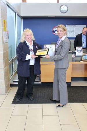 Here Monica Lee from Great Lakes Air thanks Karen Martin for the work she and her staff have done and presents a plaque acknowledging their status as winners of the company-wide Flyin' 4 Food challenge.