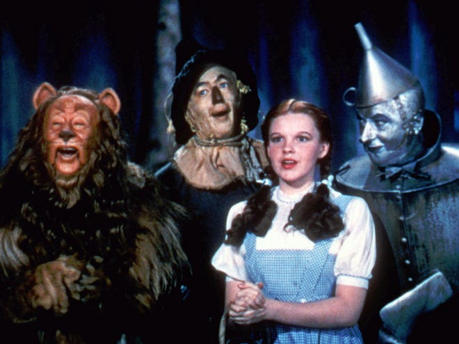 FILE- This 1939 file photo provided by Warner Bros. shows, from left, Bert Lahr as the Cowardly Lion, Ray Bolger as the Scarecrow, Judy Garland as Dorothy and Jack Haley as the Tin Woodman in a scene from "The Wizard of Oz." Judy Garland's original costume from "The Wizard of Oz" will be up for sale at Julien's Auctions in November 2012.