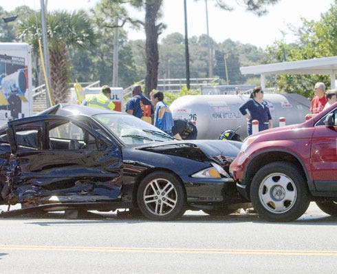 Two cars sit after a crash at Beal Parkway and McGriff Street in Fort Walton Beach on Wednesday afternoon. It was one of several accidents that occurred in a matter of minutes between Beal and Eglin Parkway.
