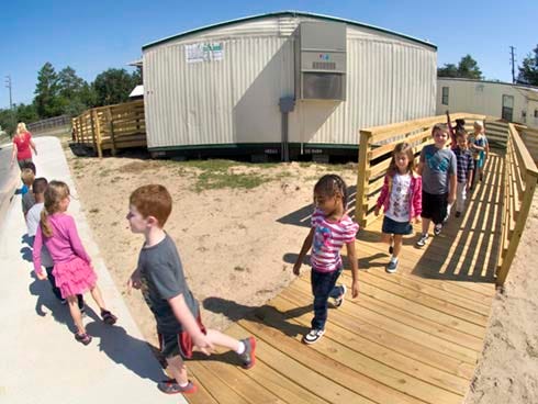 Students in Tamie Webber’s kindergarten class leave their portable classroom for recess Wednesday at Riverside Elementary School in Crestview.