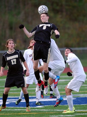 Corning's Will Cornfield gets a head on a corner kick against Elmira. Eric Wensel/The Leader