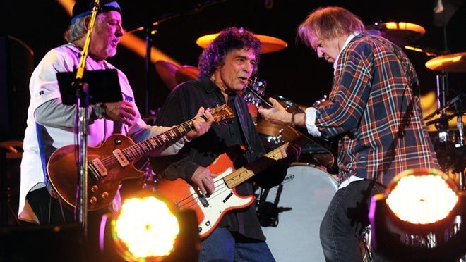 Neil Young, right, performs with his band Crazy Horse, including Frank Sampedro, left, and Ralph Molina, recently in New York. Sampedro says the ACL Fest audience can expect a lot if improv in their Saturday headlining set: “There’s no pat solo. There’s no counting bars. There’s none of that. It’s different every night. … I think the songs are just a catalyst to get us to the jam.”