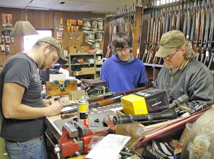 Jeremy Hornung, co-owner of Tony Gun Shop, fills out paperwork as Dale Schwiderson of Brimley and his 17-year-old step-son Scott Fischer purchased rifles on Wednesday. The Hornungs have lost their license, forcing the closure of the family-owned business which has supplied sportsman from the Eastern Upper Peninsula and beyond for more than four decades.