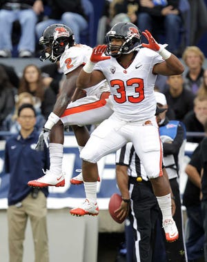 Oregon State wide receiver Markus Wheaton (2) celebrates with Tyler Anderson (33) after scoring a touchdown against Brigham Young in their NCAA college football game Saturday in Provo, Utah. No. 10 Oregon State won, 42-24.