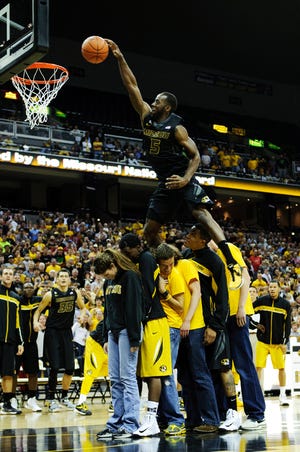 Missouri guard Keion Bell leaps over two teammates and four students during Friday night’s dunk contest during the Mizzou Madness basketball event at Mizzou Arena. Bell won the contest.