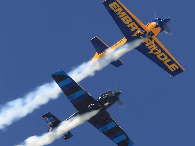 Matt Chapman, top, and Rob Holland race each other into the sky during Embry-Riddle Aeronautical University’s Wings and Waves Air Show in Daytona Beach on Sunday.