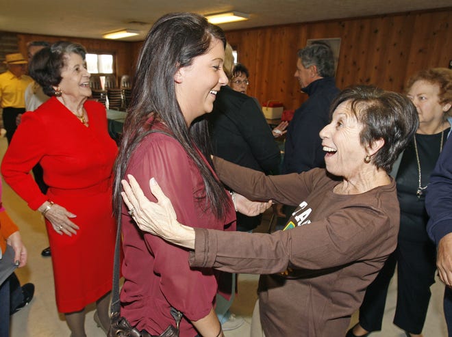 Anna Carozzi, right, greets her neice Stephanie Guidone during a family reunion at Dogwood Park in North Canton Saturday. At far left is Anna's sister Helen Gialluca. Anna and Helen's father Sabatino Guidone came to the U.S. in 1912 as a 15 year old boy and married a Canton girl. He passed away in 1987. More than 100 relatives attended the event including seven of Sabatino and Esther's 11 children, Anna Carozzi, Lillian Boyajian, Genevieve Stiner, Helen Gialluca, Paul Guidone, Gene Guidone, and John Guidone. Frank Guidone lives in California and did not attend. Julius Guidone, Samuel Guidone and Mary Gialluca had passed away. In addition to Sabatino and Esther's 11 children they have 36 grandchildren, 67 great grandchildren and 28 great great grandchildren.