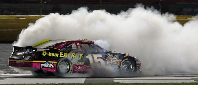 Clint Bowyer does a burnout to celebrate his win Saturday at Charlotte Motor Speedway.