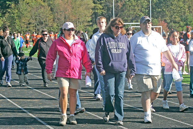 From left, Taunton High School guidance counselor, Julie Barbour, Taunton City Councilors Debbie Carr and Dan Barbour take part in the Gertrude Dermody Walk for Literacy.