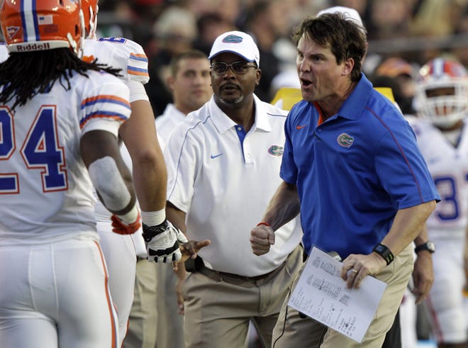 Florida head coach Will Muschamp, right, yells at his players during the second quarter of an NCAA college football game against Vanderbilt on Saturday in Nashville, Tenn.