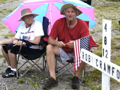 In July, Jeff Crawford and his his wife, Ann, spent a weekend sitting near where his brother was killed surrounded by yellow signs that read, “Justice for Robert Crawford.” He plans to do the same thing again.
