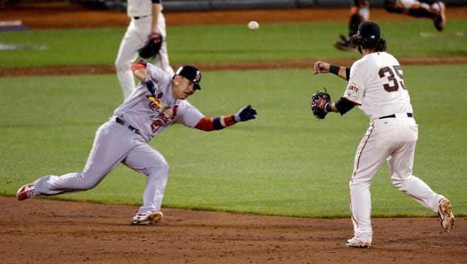 St. Louis' Allen Craig (21) is out at second as San Francisco's Brandon Crawford (35) turns a double play during Game 1 of the National League Championship Series on Sunday in San Francisco. The Cardinals won, 6-4.