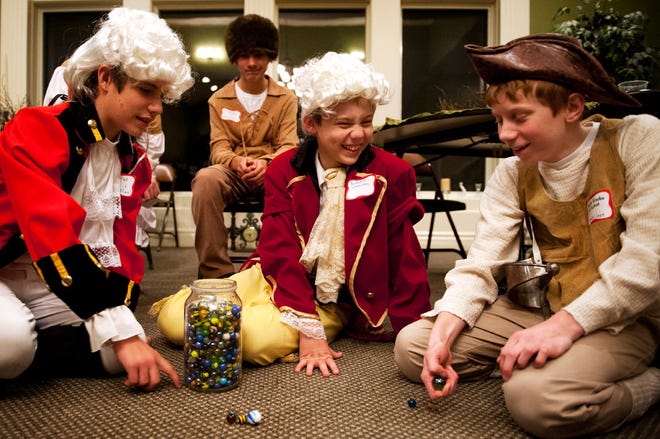From left, Christian Fellowship School students Joey Burris, Alex Dart and Braden Wakeman participate in the school’s Colonial Ball Monday.