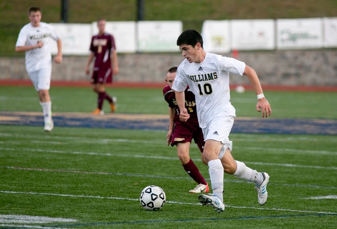 Archbishop Williams' Shane Moriarty of Weymouth gets past Cardinal Spellman's Thomas Grzybinski in the first half of a high school soccer game on Monday, Oct. 15, 2012.
