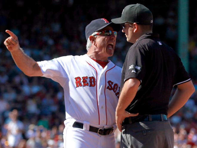 Red Sox manager Bobby Valentine, left, argues a call with first base umpire Dan Bellino, right, after Red Sox's Dustin Pedroia was called out at first base in the fifth inning of a baseball game against the Kansas City Royals at Fenway Park in Boston, Sunday. Valentine was thrown out of the game. (AP Photo/Steven Senne)
