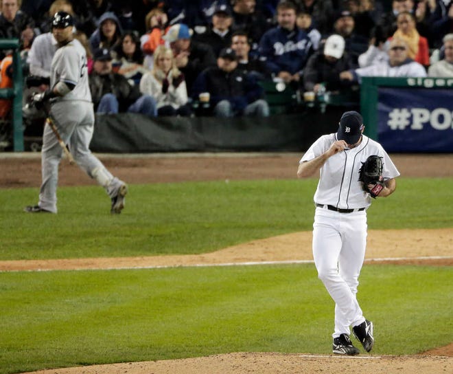 The Detroit Tigers' Justin Verlander adjusts his hat after striking out the New York Yankees' Robinson Cano, left, in the seventh inning of Game 3 of the American League Championship Series on Tuesday in Detroit. The Tigers lead the series 3-0 after Tuesday's 2-1 win.