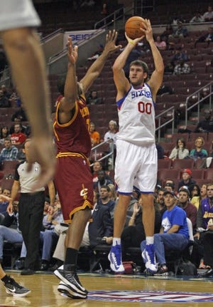 The Sixers' Spencer Hawes shoots a jumper over the Cavaliers' Samardo Samuels during the second half of Wednesday's preseason game at the Wells Fargo Center.