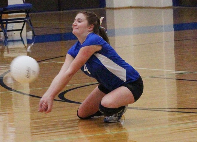 Ionia's Joanna Miller digs the ball on a Grand Ledge kill attempt Thursday night during the Bulldogs' CAAC Tournament match against the Comets.
