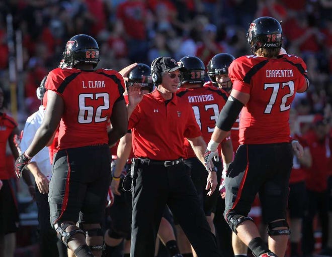 Texas Tech head coach Tommy Tuberville greets Le'Raven Clark(62) and Beau Carpenter(72) during their game on Saturday in Lubbock. The emergence of the Red Raiders' offensive line has been key this season. (Stephen Spillman)