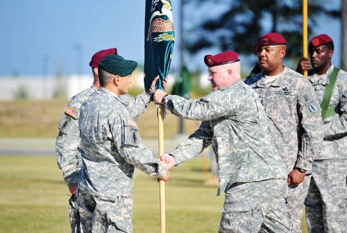 Col. Miguel D. Howe (left), Deputy Commander, 7th Special Forces Group (Airborne) passes the colors to Lt. Col. Dennis H. Levesque, incoming commander, Group Support Battalion, during the change of command ceremony on Meadows Field on Sept. 27. (Right) Lt. Col. Ron L. Baker, outgoing commander, relinquished command of the Group Support Battalion in a traditional Army ceremony to Lt. Col. Dennis H. Levesque.