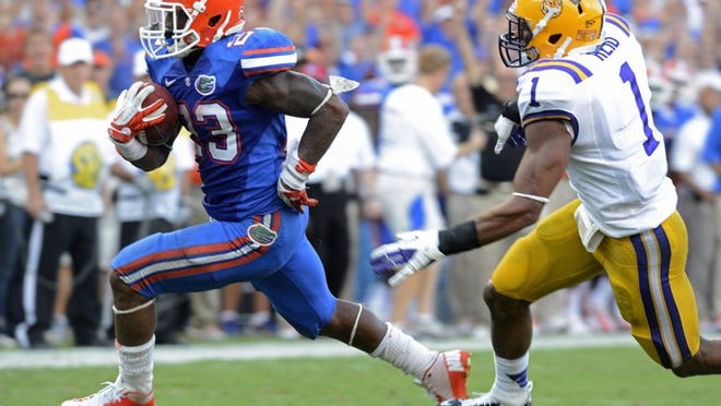 Florida’s Mike Gillislee sprints away from LSU safety Eric Reid for Gillislee’s second touchdown in the Gators’ victory Oct. 6. Gillislee and quarterback Jeff Driskel are the key components of a ground game that is producing 233.3 yards per game, No. 14 nationally. (Phil Sandlin/Associated Press)