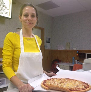 Anna's co-owner Anna Chiarelli with a carryout order.