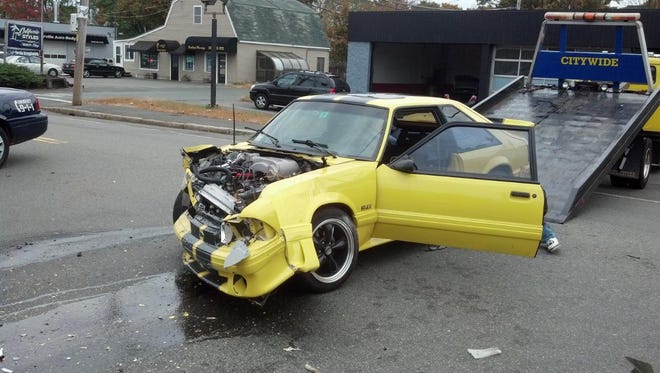 The driver of this Ford Mustang reportedly became enraged at the price of gas Friday morning and sped out of the Hess station on Main Street in Brockton, colliding with a minivan.