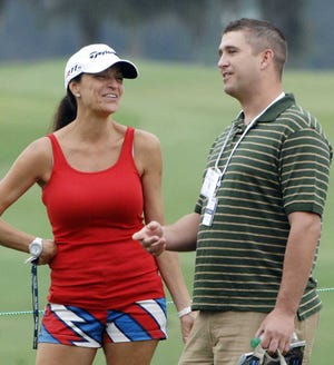 Terry.Dickson@jacksonville.com Sgt. Travis Bassett, a wounded soldier from Fort Stewart, Ga., talks with John Daly's girlfriend, Anna Cladakis, on the 15th hole of the McGladrey Classic.