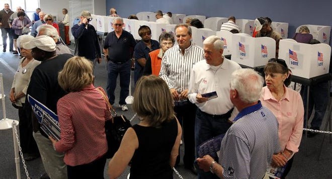 (Photo by John Clark) Early voting Thursday at the Board of Elections office.