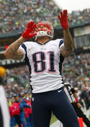 New England Patriots' Aaron Hernandez celebrates after making a catch for a touchdown in the first half of a game against the Seattle Seahawks.