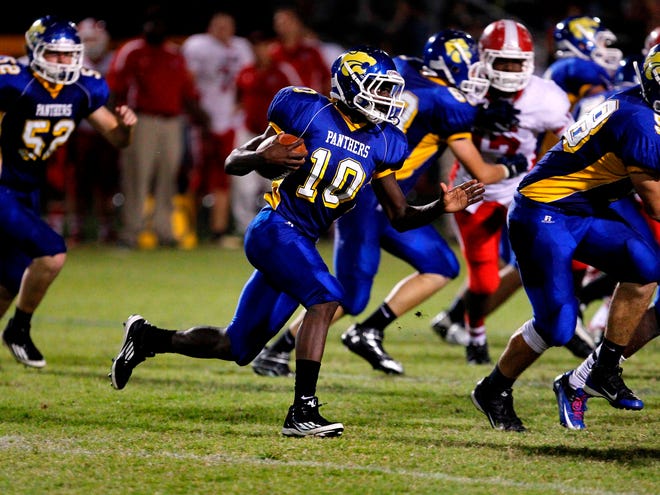 Newberry player Dylan Reed runs with the ball during a game against Dixie County, in Newberry on Friday.