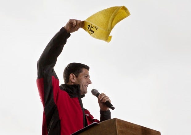 Republican vice presidential nominee Paul Ryan waves a Romney/Ryan towel at a rally at Atlantic Aviation on Saturday morning.